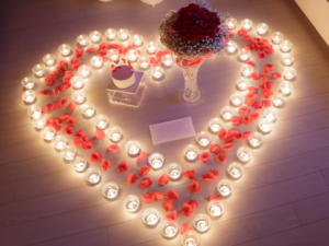 social events image of a heart made out of red rose petals and votive candles